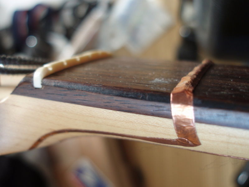Copper tape on the guitar frets, from the OpenChord project
